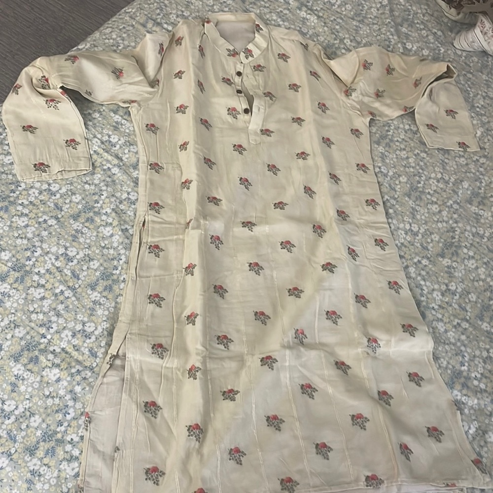 Indian traditional designed kurti.It has liegt beige color with flower embroider